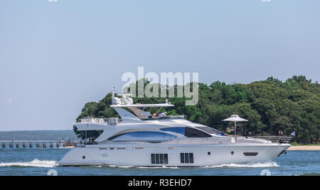 large yacht underway with North Haven and Sag Harbor in the background Stock Photo