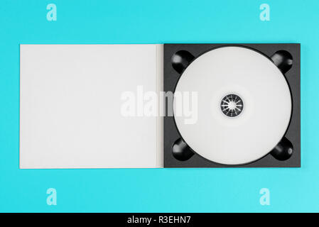 White cd in black case on pastel green background Stock Photo