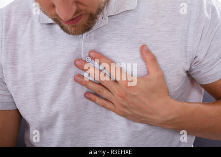 Man Touching His Chest While Suffering From Pain Stock Photo