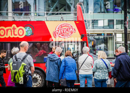 tourists lining up for toronto sightseeing bus red double decker tour bus Stock Photo