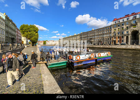 Tourists disembark from two river tour cruise boats on the River Neva in the city of St. Petersburg, Russia. Stock Photo