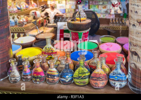 DUBAI, UAE - November 12, 2018: souvenir shop in Atlantis hotel with souvenirs bottles filled with colored sand in camel form Stock Photo