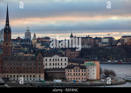 Riddarholmen viewed from a roof on Vasagatan, Stockholm, Sweden, during a dramatic colored cloudy evening Stock Photo