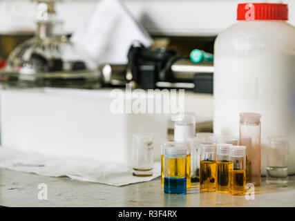Sample test tubes containing coloured liquid in a chemistry laboratory ...