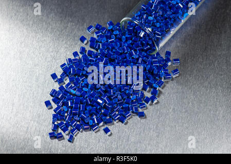 blue plastic pellets into test tubes Stock Photo