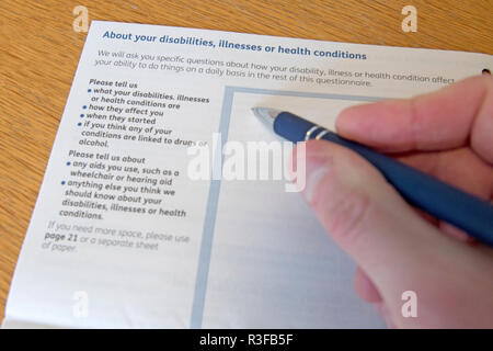 A picture shows a Universal Credit Capability for Work questionnaire form being filled out by a person off work with long term illness. UK. Nov 18. Stock Photo