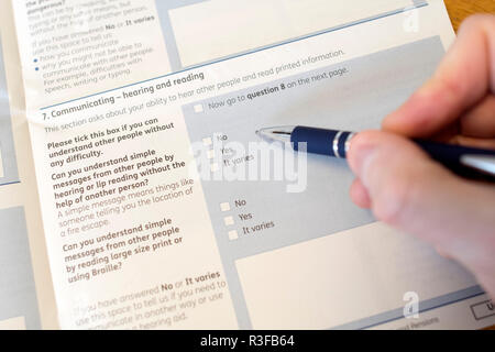 A picture shows a Universal Credit Capability for Work questionnaire form being filled out by a person off work with long term illness. UK. Nov 18. Stock Photo