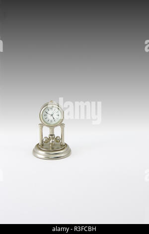 Miniature clock in which the hands mark the four forty-nine with a black and white background Stock Photo