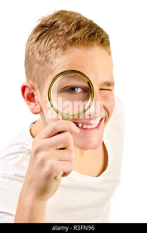 teenage boy with magnifier isolated on a white background Stock Photo