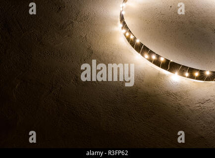 simple minimalist and effective Christmas decoration ornament wall hanging of metal ring with chain of lights Stock Photo