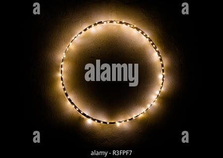 simple minimalist and effective Christmas decoration ornament wall hanging of metal ring with chain of lights Stock Photo