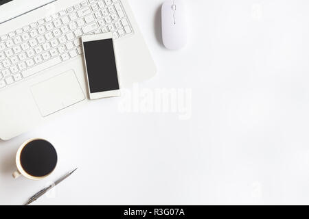 White desk office with laptop, smartphone and other work supplies with cup of coffee. Top view with copy space for input the text. Designer workspace  Stock Photo