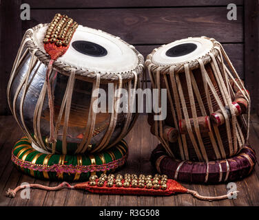 Tabla drums and bells for Indian dancing on wooden background Stock Photo