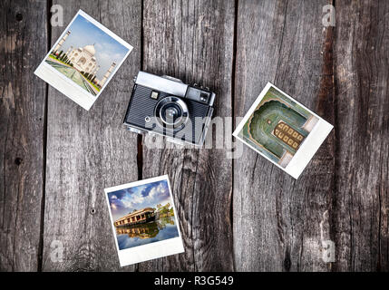 Old film camera and polaroid photos with Indian famous landmarks on the wooden background Stock Photo