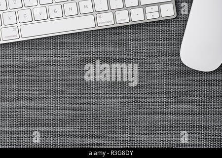 Business composition with white computer keyboard and mouse on grey background. Top view with copy space for text. Stock Photo