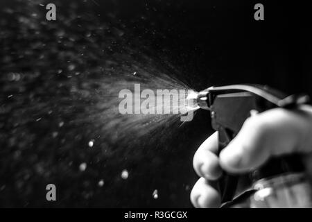 Water jet spraying on black background Stock Photo