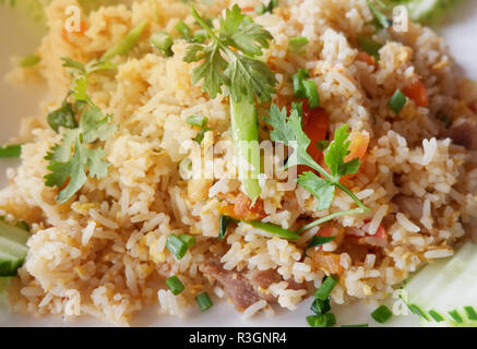 Fried rice chicken egg / Rice fried egg and vegetable carrot chinese kal on plate with green onion and cucumber Stock Photo