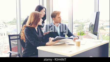 Businessmen and using notebook pc and tablet for discussing documents and ideas in meeting  and business serious for working Stock Photo
