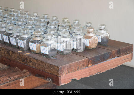 Collage of rocks and minerals, semiprecious stones in the glass jars Stock Photo