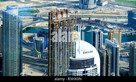 Standing on the Burj Khalifa tower in Dubai city and looking at the urban development in the downtown district on the east side. Stock Photo