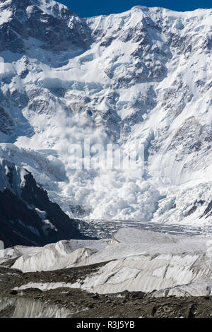 Avalanche coming down near Base Camp, Pabeda-Khan Tengry glacier massif, Central Tien Shan Mountain Range Stock Photo