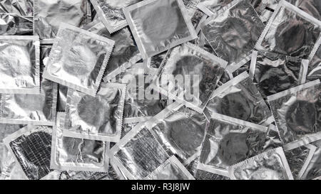 top view of pile of silver condoms Stock Photo