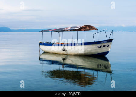 Small Boat reflecting in Ohrid lake, Ohrid, Macedonia Stock Photo