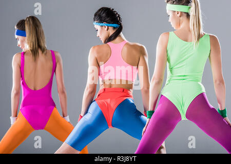beautiful sporty girls in 80s style sportswear exercising together on grey  Stock Photo - Alamy