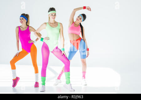 attractive sporty girls in 80s style sportswear posing together on grey  Stock Photo - Alamy