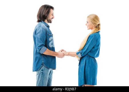 Amazing couple holding hands and amorously looking at each other isolated on white Stock Photo