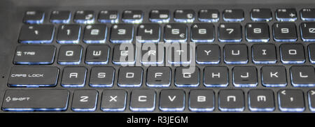 A close up of a backlit computer keyboard. Stock Photo