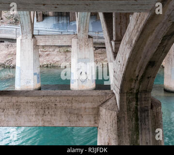 AUSTIN, TEXAS - DECEMBER 30, 2017: A graffitied smiley face on a bridge pillar along Barton Creek Springs. Stock Photo