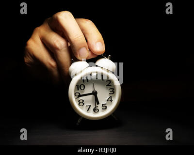 Time management. Hand is holding alarm clock. Stock Photo