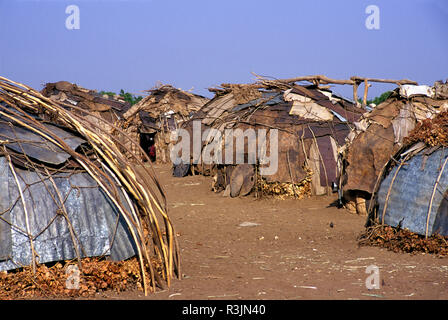 Africa, Ethiopia, Omo region. Galeb tribe houses made of grass, cloth and sheets of tin. Stock Photo