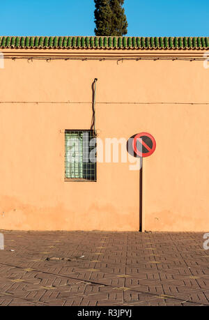 No parking sign in front of red-orange wall in Marrakech (Marrakesh), Morocco Stock Photo
