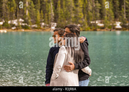 LAKE LOUISE, AB, CANADA - JUNE 2018: Group of friends posing for a picture alongside Lake Louise in Alberta, Canada. Stock Photo