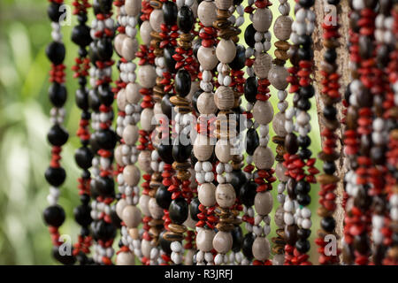 Madagascar, Nosy Be (Big Island) off the northwest coast of mainland Madagascar. Rural roadside handicraft stand selling seed necklaces. Stock Photo