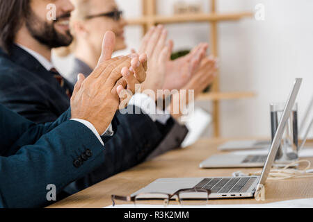 happy business people clapping hands at meeting in office Stock Photo