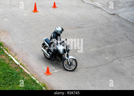 Man is practicing driving a motorcycle in a driving school Stock Photo