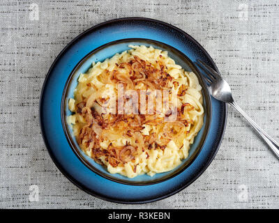 Traditional Swabian "Käsespätzle" - a dish of egg and flour noodles with grated cheese and fried onions. Also spelled kaesespaetzle Stock Photo