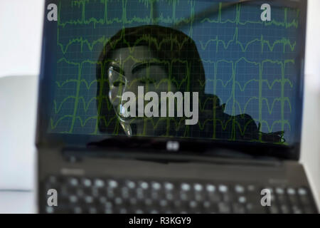 hacker in computer ,anonymous mask Stock Photo