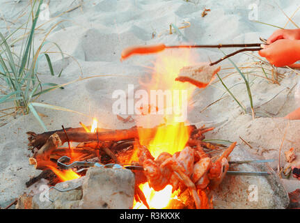 to warm slices of bread on a fire, to fry bread on a grill Stock Photo