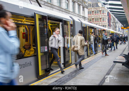 Manchester, UK. 23rd November, 2018. Shoppers arriving by MetroLink tram on Black Friday Sales Busy Weekend.  City centre holiday shopping season, retail shops, stores, Christmas shoppers, discount sale shopping, female consumer spending on Black Friday weekend considered to be the biggest shopping event of the year.   U.K. retailers have embraced the USA style sale bonanza, with many customers left surprised by bargain discounts, enjoying a Xmas spend & carrying a number bags, gifts, presents and sale items. Credit: MediaWorldImages/AlamyLiveNews. Stock Photo
