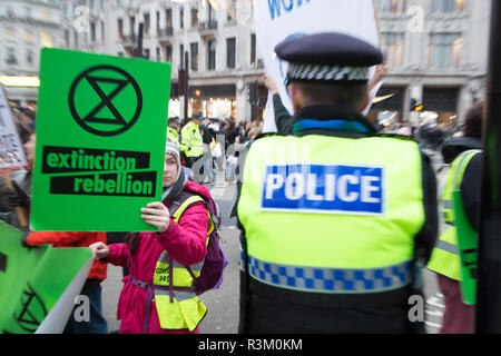 London UK 23 November 2018 Climate change activists from the Extinction Rebellion group block Oxford Street in Central London in protest that the government is not doing enough to avoid catastrophic climate change and to demand the government take radical action to save the planet. Credit: Thabo Jaiyesimi/Alamy Live News Stock Photo