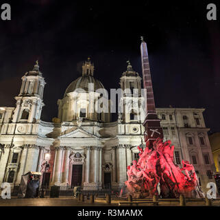 navona square baroque roma by night with coulorated fountain four revers, quattro fiumi with panorama st agnese church Stock Photo