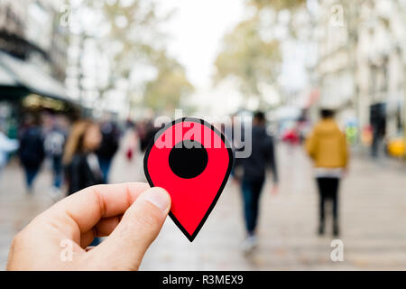 closeup of the hand of a young caucasian man with a red marker in the popular Las Ramblas in Barcelona, Spain Stock Photo