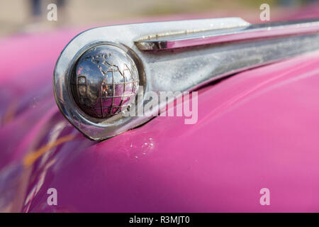 Cuba, Havana. Globe hood ornament on pink classic car. Credit as: Wendy Kaveney / Jaynes Gallery / DanitaDelimont.com Stock Photo