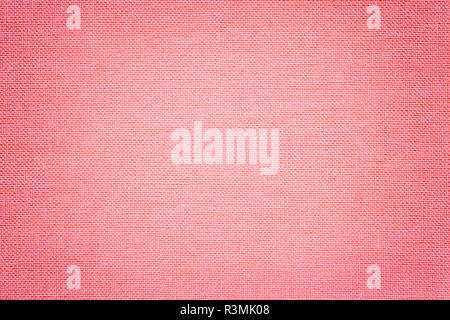 Light pink background from a textile material with wicker pattern, closeup. Structure of the rose fabric with texture. Cloth backdrop with vignette. Stock Photo