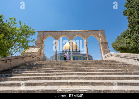 Muslim women looking at the Dome of the Rock. It is an Islamic shrine located on the Temple Mount in the Old City of Jerusalem. Stock Photo
