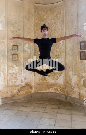 Cuba, Havana. Male dancer makes ballet move. Credit as: Wendy Kaveney / Jaynes Gallery / DanitaDelimont.com Stock Photo